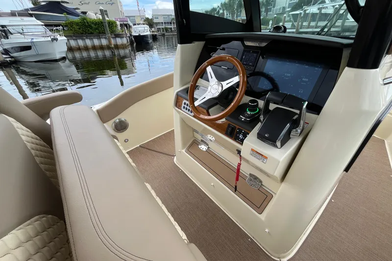 Slide: The Image of 2025 Chris-Craft Catalina 28 helm with modern controls and wooden steering wheel. - 15