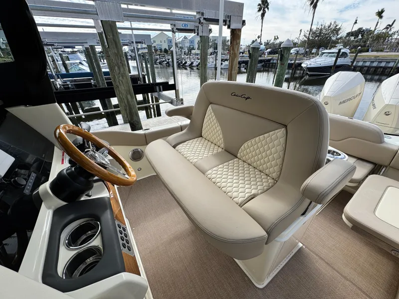 Slide: The Image of 2025 Chris-Craft Catalina 28 interior with luxurious seating and elegant steering wheel. - 17