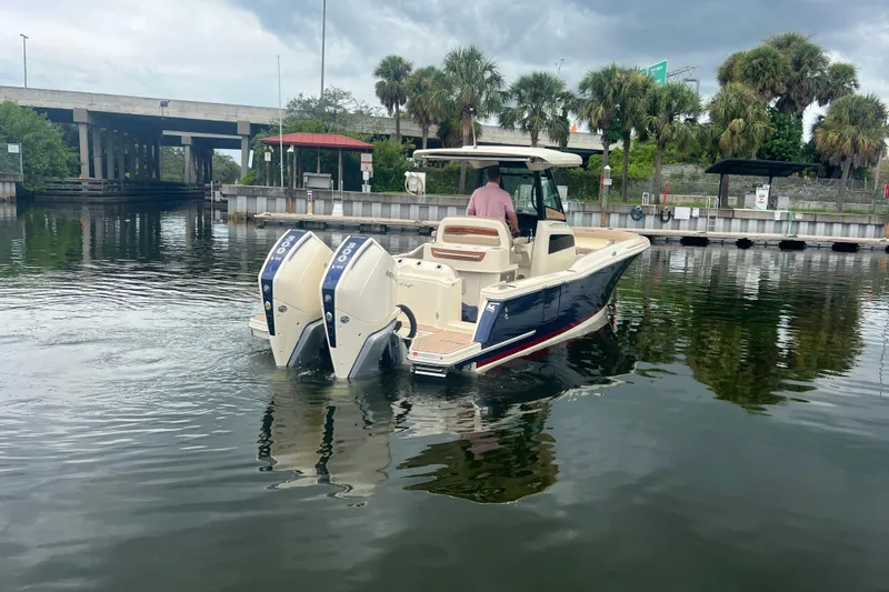 Slide: The Image of 2025 Chris-Craft Catalina 28 boat with dual engines on a calm waterway. - 2