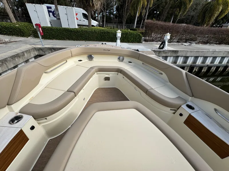 Slide: The Image of 2025 Chris-Craft Catalina 28 boat interior with beige seating and wood accents. - 22