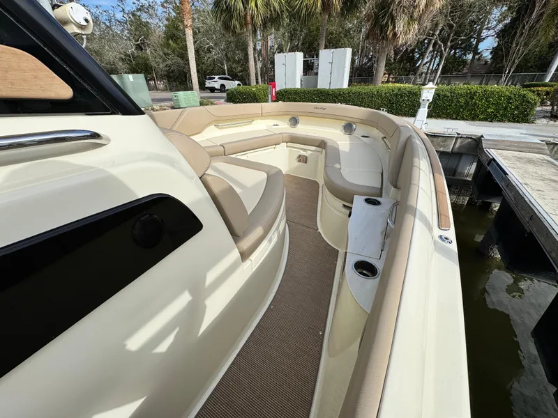 Slide: The Image of 2025 Chris-Craft Catalina 28 boat interior with beige seating and cup holders. - 24