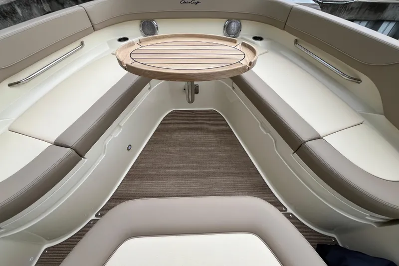 Slide: The Image of 2025 Chris-Craft Catalina 28 interior with elegant seating and wooden table. - 28
