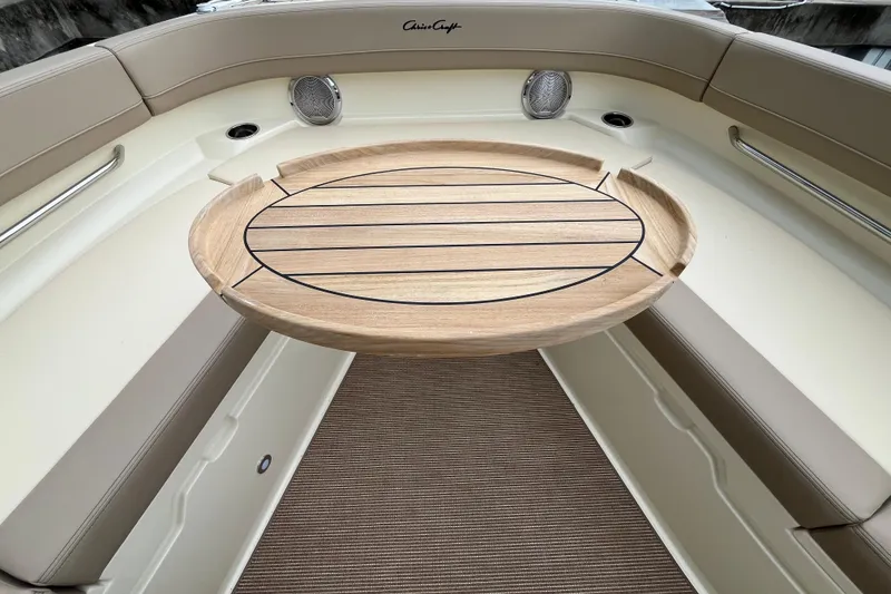 Slide: The Image of 2025 Chris-Craft Catalina 28 interior with wooden table and beige seating. - 29
