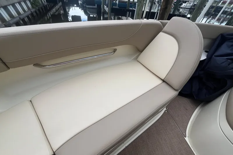 Slide: The Image of 2025 Chris-Craft Catalina 28 boat interior with beige seating and stainless steel handrail. - 31