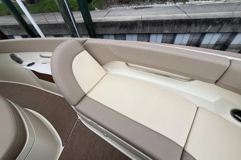 Slide: The Image of 2025 Chris-Craft Catalina 28 boat interior with beige seating and cup holder. - 32