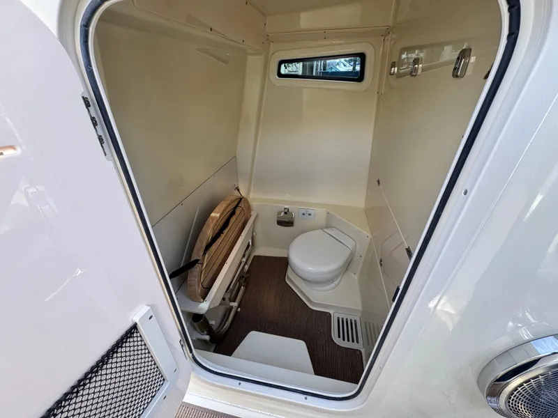 Slide: The Image of 2025 Chris-Craft Catalina 28 boat bathroom interior with toilet and window. - 37