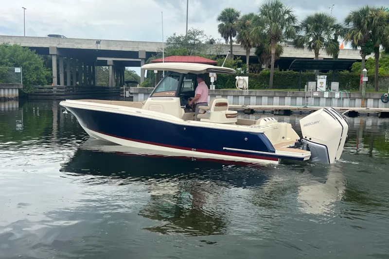 Slide: The Image of 2025 Chris-Craft Catalina 28 boat on water, featuring sleek design and powerful Mercury engines. - 4