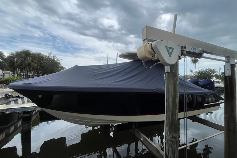 Slide: The Image of 2025 Chris-Craft Catalina 28 boat covered and docked under cloudy skies. - 40