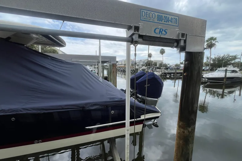 Slide: The Image of 2025 Chris-Craft Catalina 28 boat covered and docked at a marina. - 41