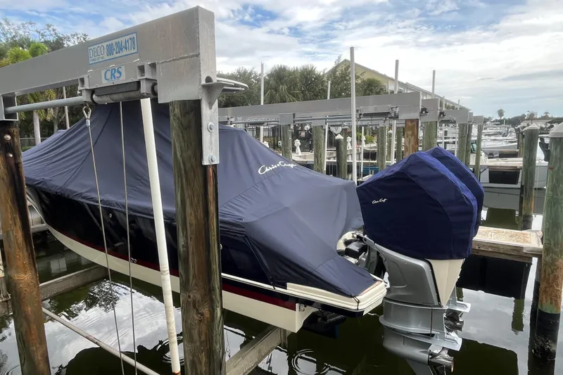 Slide: The Image of 2025 Chris-Craft Catalina 28 boat covered and docked at a marina. - 42