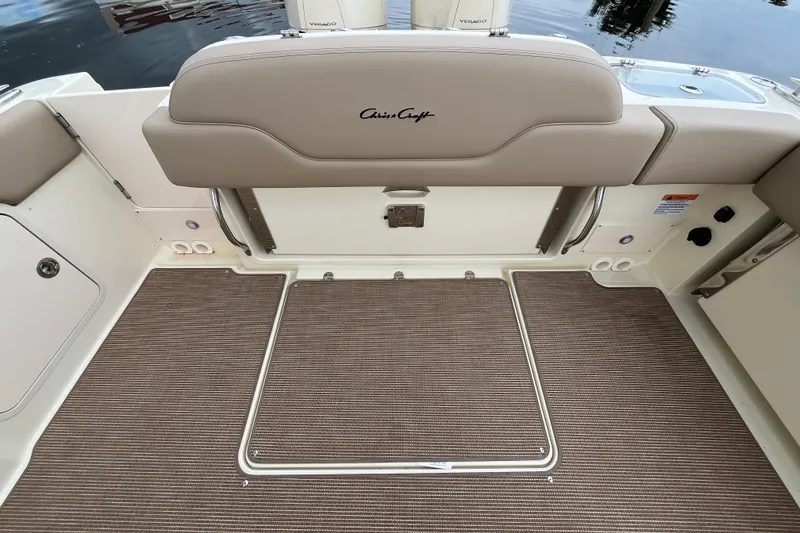 Slide: The Image of 2025 Chris-Craft Catalina 28 boat interior with beige seating and carpeted flooring. - 7
