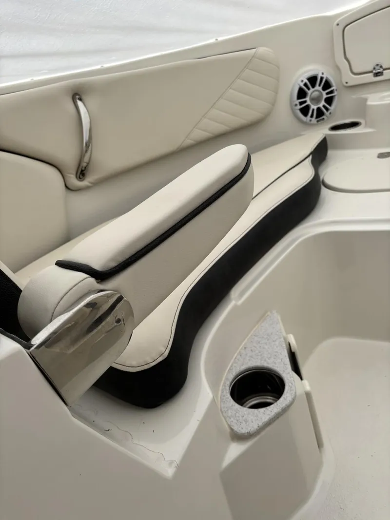 Slide: The Image of 2024 Stingray 23 OSX boat interior with white seating and cup holder. - 18