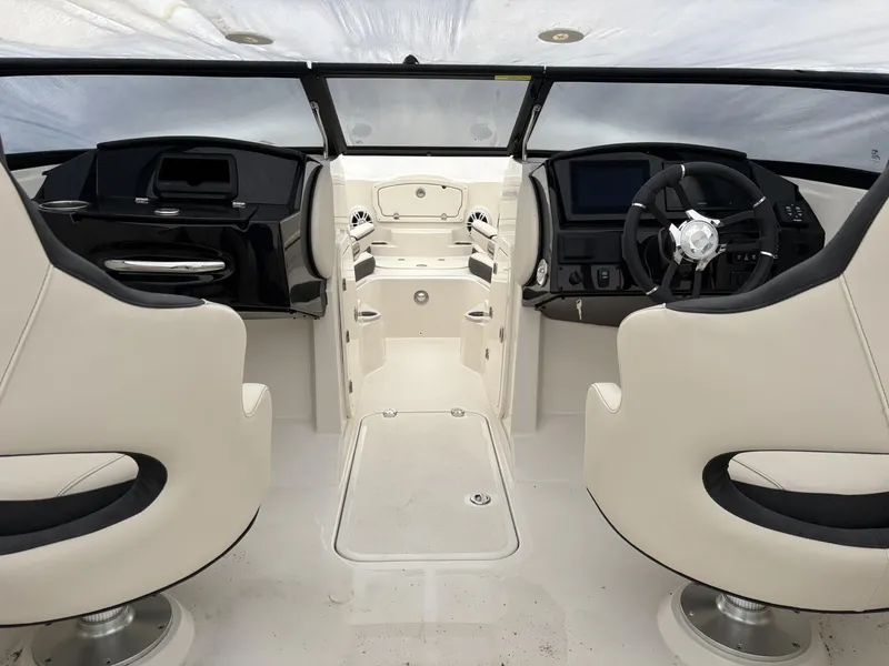 Slide: The Image of 2024 Stingray 23 OSX boat interior with dual helm seats and modern dashboard. - 21