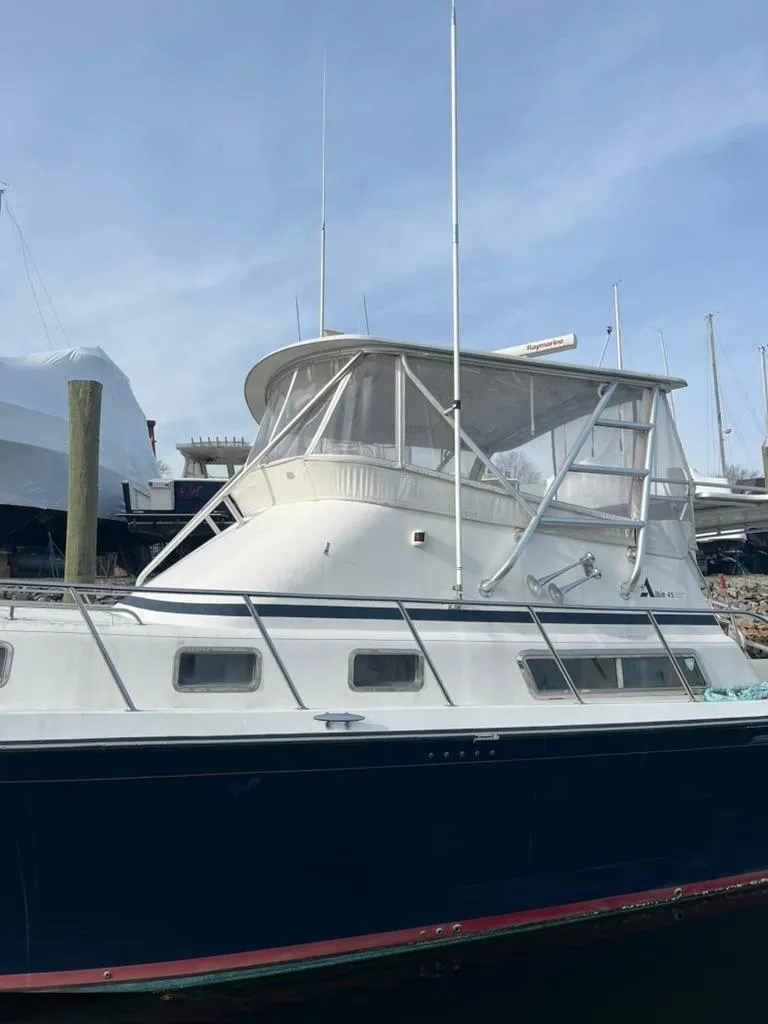 Slide: The Image of 2005 Albin 45 Command Bridge yacht with enclosed flybridge, docked at marina. - 16
