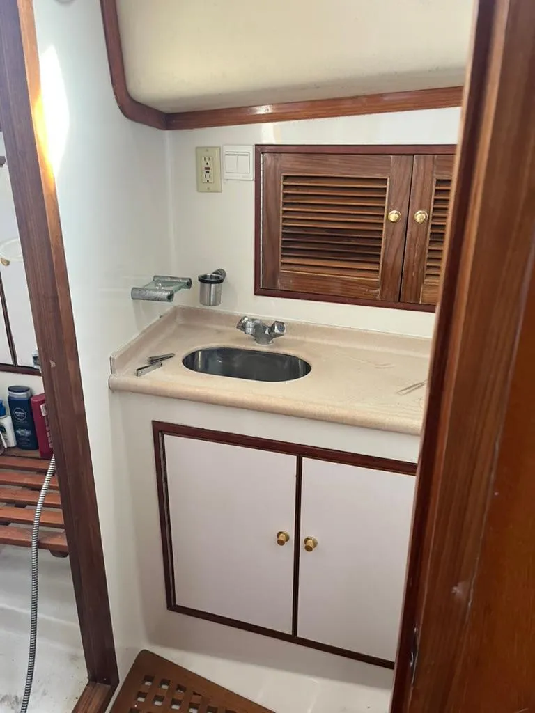 Slide: The Image of 2005 Albin 45 Command Bridge bathroom with sink and wooden cabinets. - 4