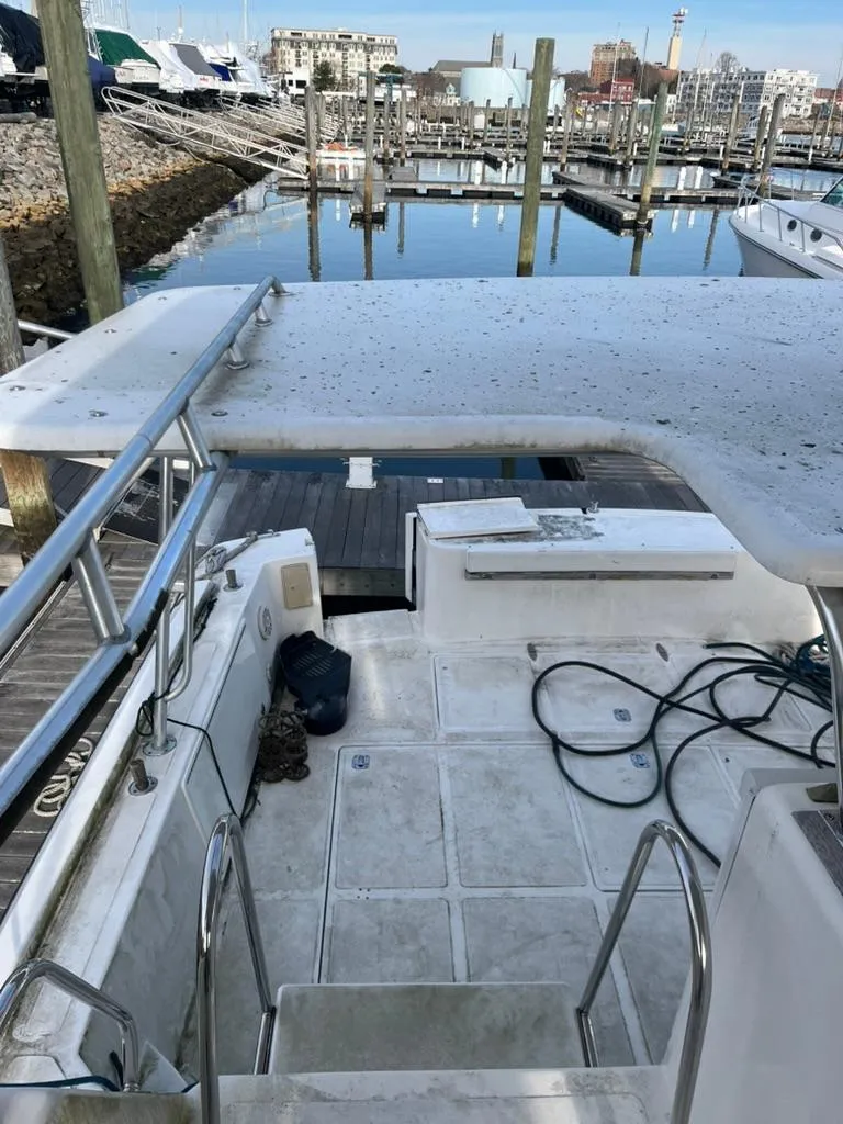 Slide: The Image of 2005 Albin 45 Command Bridge yacht docked at marina, view of deck and seating area. - 8