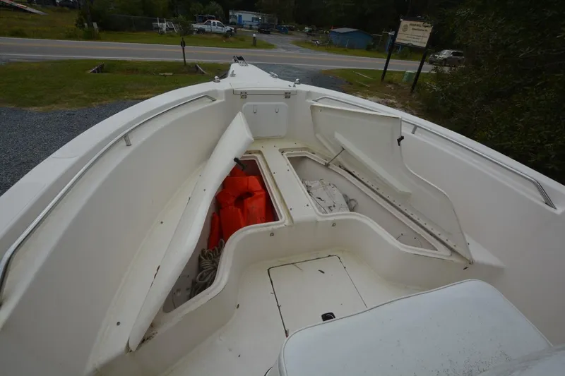 Slide: The Image of 1999 Hydra-Sports 2450 CCH boat interior with storage compartments and life jackets. - 10