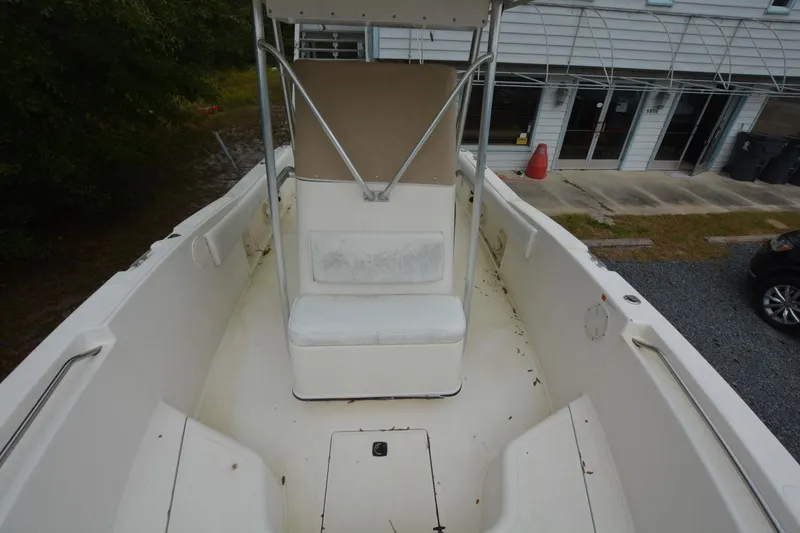 Slide: The Image of 1999 Hydra-Sports 2450 CCH boat interior, white seating, and console view. - 11