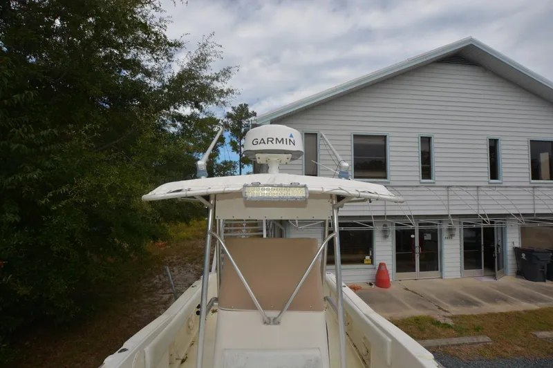 Slide: The Image of 1999 Hydra-Sports 2450 CCH boat with Garmin radar, parked near a building. - 12