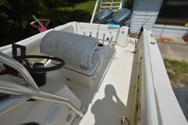 Slide: The Image of 1999 Hydra-Sports 2450 CCH boat interior with steering console and dual Yamaha engines. - 13