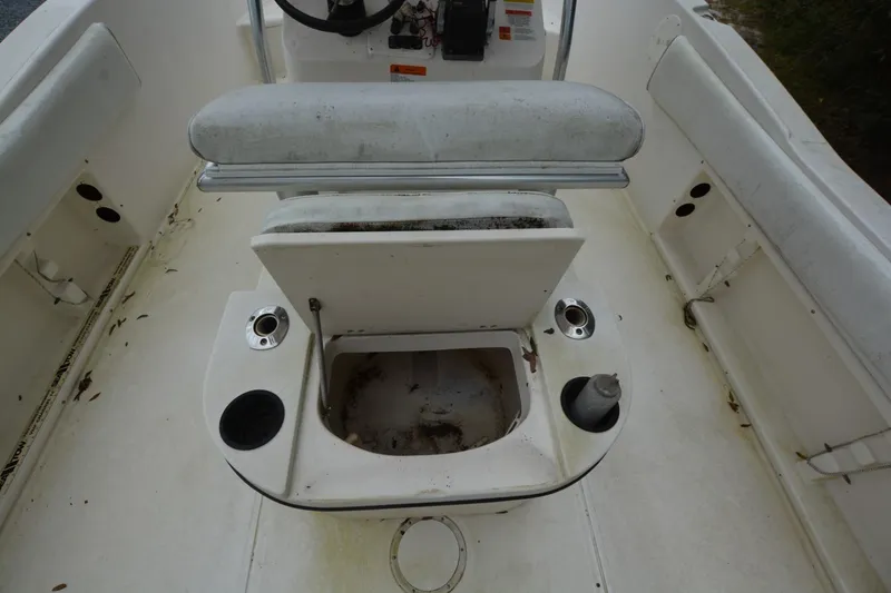 Slide: The Image of 1999 Hydra-Sports 2450 CCH boat interior with open storage compartment and seating. - 16