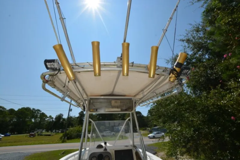 Slide: The Image of 1999 Hydra-Sports 2450 CCH boat with rod holders under sunny sky. - 17