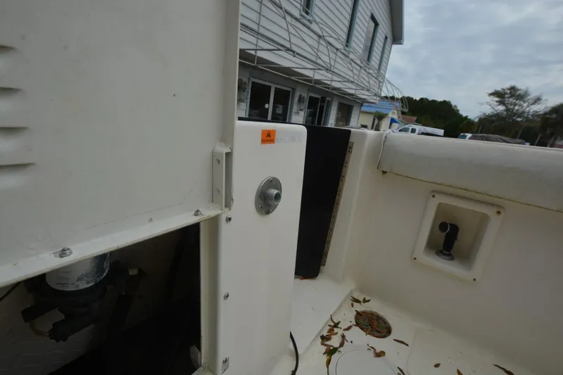 Slide: The Image of 1999 Hydra-Sports 2450 CCH boat interior with leaves and building in background. - 18