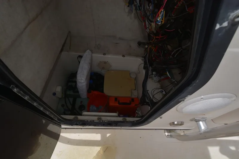 Slide: The Image of Interior view of a 1999 Hydra-Sports 2450 CCH boat compartment with wiring and equipment. - 20
