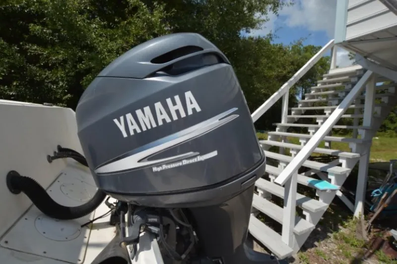 Slide: The Image of Yamaha outboard motor on 1999 Hydra-Sports 2450 CCH boat, near white stairs. - 22
