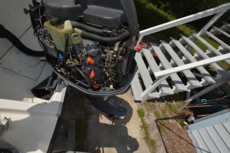 Slide: The Image of 1999 Hydra-Sports 2450 CCH boat engine near white stairs, outdoor setting. - 23