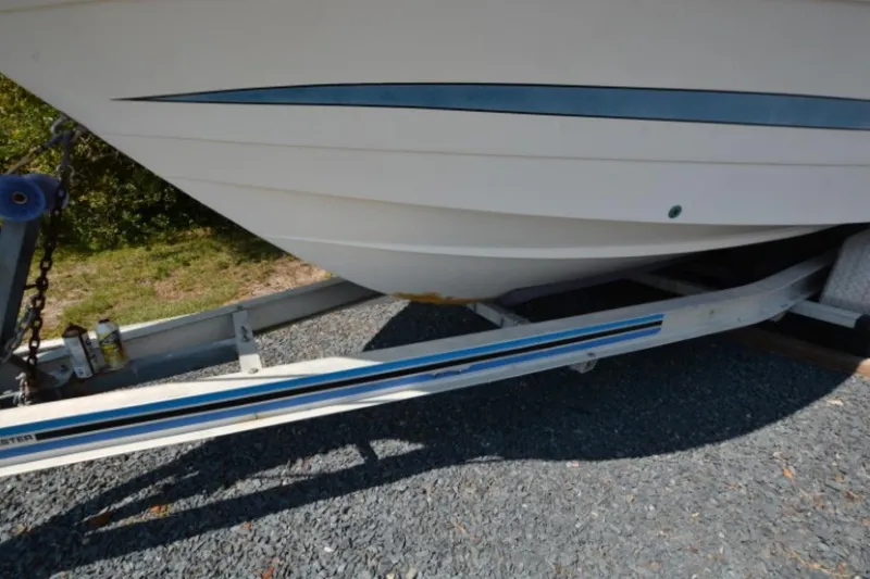 Slide: The Image of 1999 Hydra-Sports 2450 CCH boat on trailer, parked on gravel. - 3