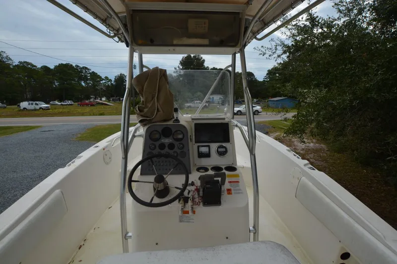 Slide: The Image of 1999 Hydra-Sports 2450 CCH boat cockpit with steering wheel and control panel. - 6