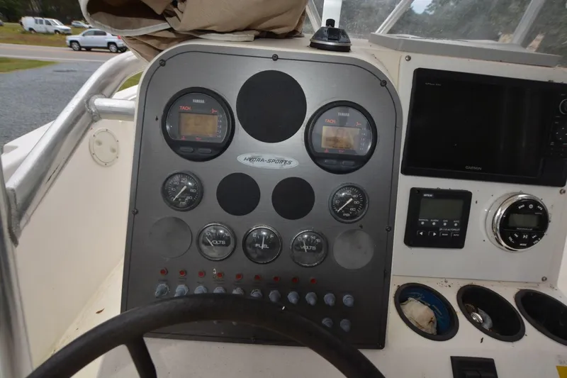 Slide: The Image of Dashboard of a 1999 Hydra-Sports 2450 CCH boat with gauges and controls. - 7