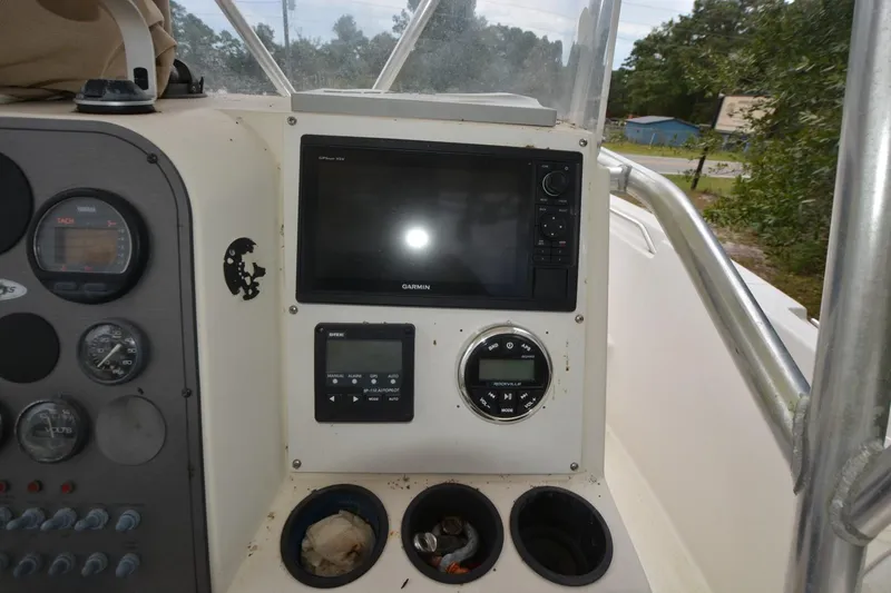 Slide: The Image of 1999 Hydra-Sports 2450 CCH boat dashboard with navigation equipment and gauges. - 8