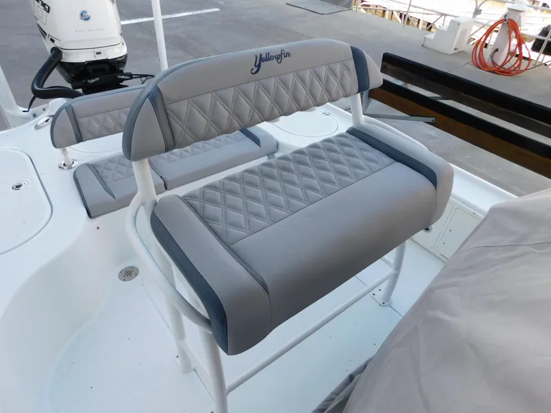 Slide: The Image of 2018 Yellowfin 24 Bay boat with cushioned seating and sleek design. - 15