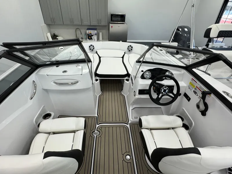 Slide: The Image of 2025 Stingray 191 DC boat interior with white seating and modern dashboard. - 15
