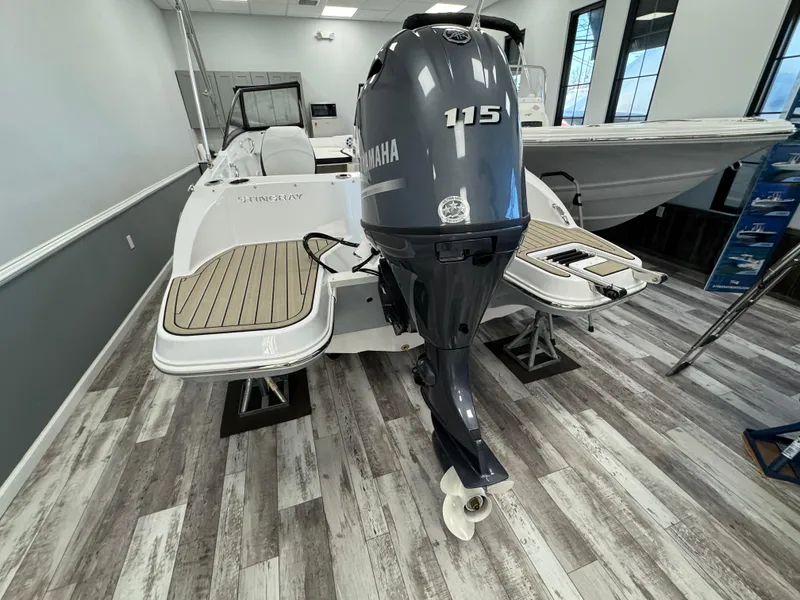 Slide: The Image of 2025 Stingray 191 DC boat with Yamaha 115 outboard motor in showroom. - 3
