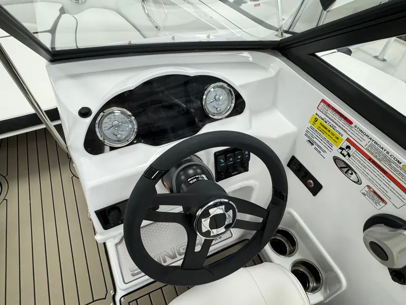 Slide: The Image of 2025 Stingray 191 DC boat dashboard with steering wheel and gauges. - 6