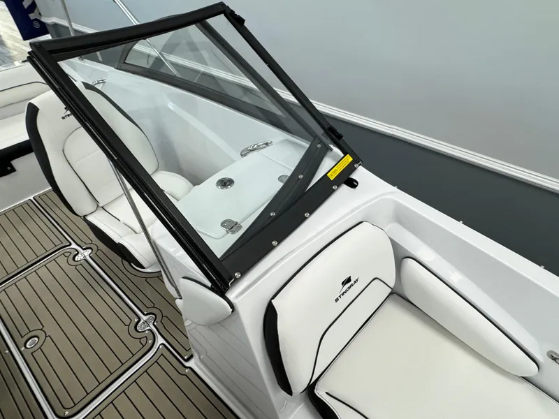 Slide: The Image of 2025 Stingray 191 DC boat interior with white seating and sleek design. - 9