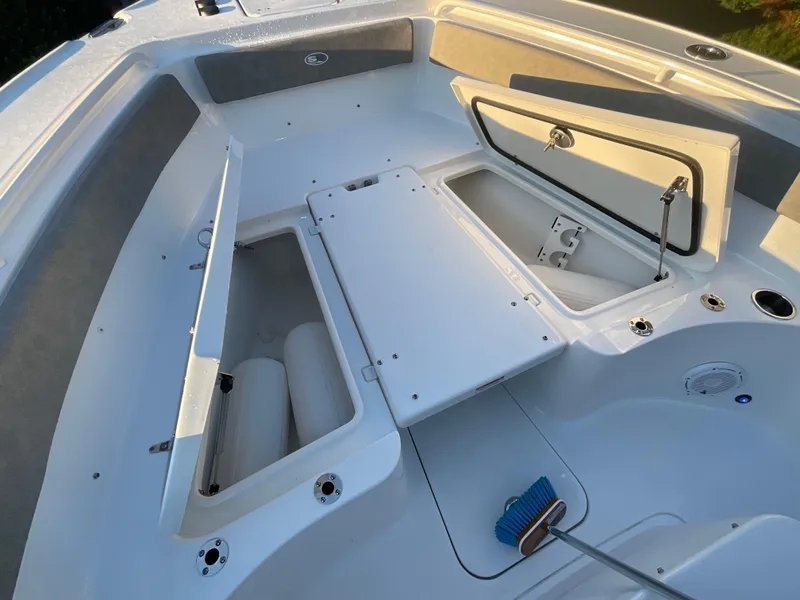Slide: The Image of 2024 Sea Hunt Ultra 265 SE boat interior with open storage compartments. - 10