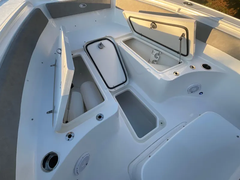 Slide: The Image of 2024 Sea Hunt Ultra 265 SE boat storage compartments and seating area. - 11
