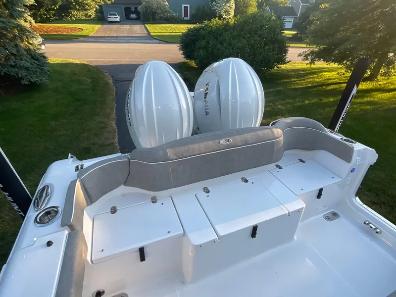 Slide: The Image of 2024 Sea Hunt Ultra 265 SE boat with dual engines, rear seating, and storage compartments. - 15