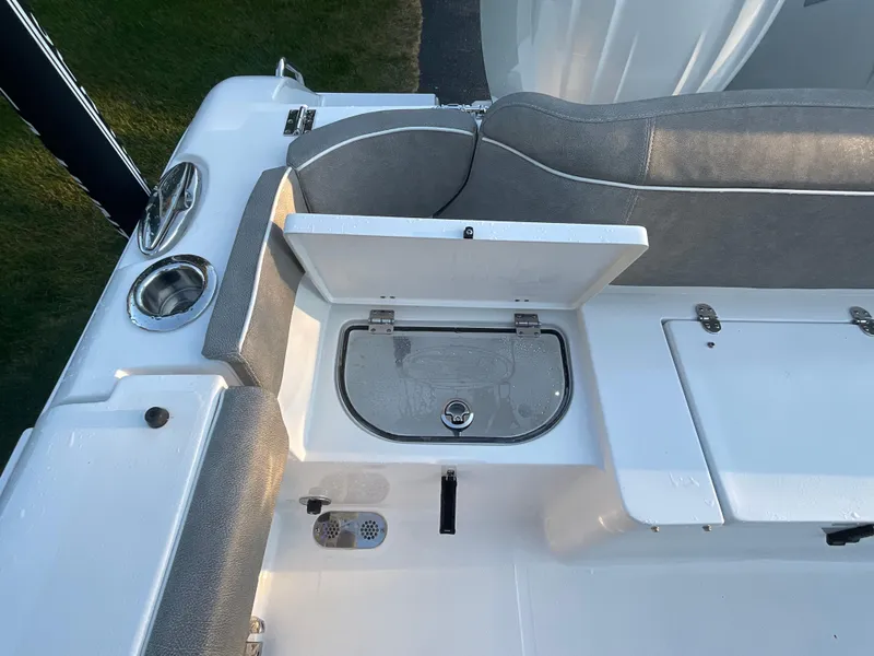 Slide: The Image of 2024 Sea Hunt Ultra 265 SE boat interior with storage compartments and seating. - 17