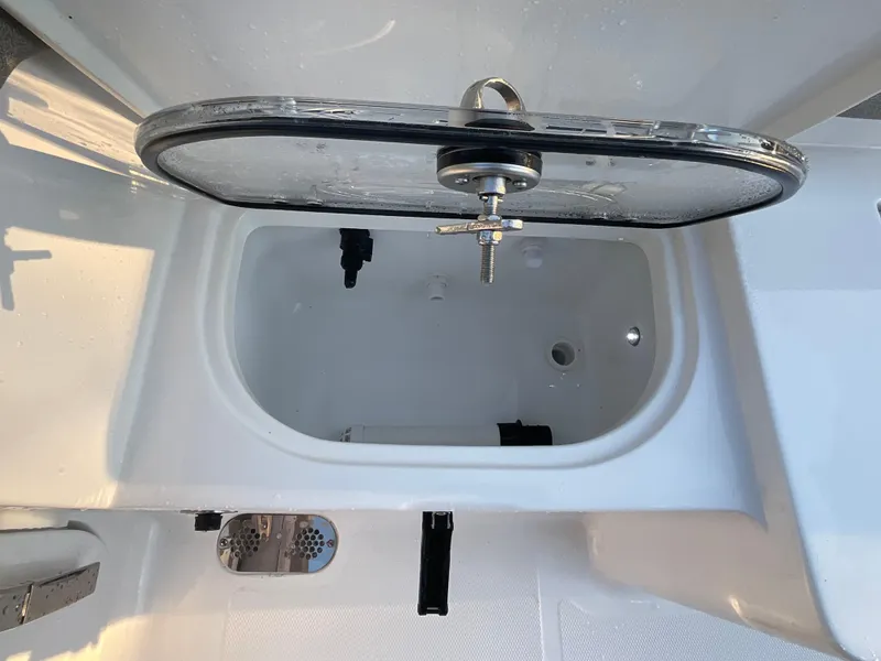 Slide: The Image of 2024 Sea Hunt Ultra 265 SE livewell with open lid, showcasing interior design. - 18