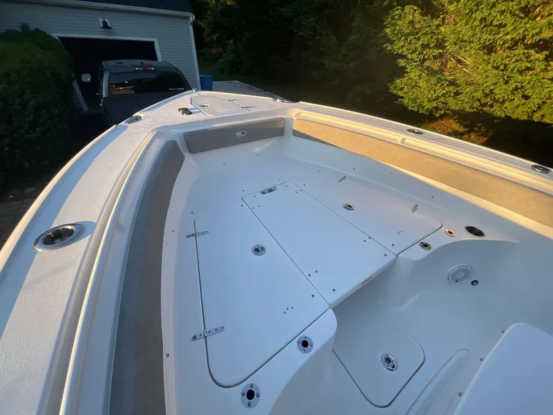 Slide: The Image of 2024 Sea Hunt Ultra 265 SE boat deck, featuring spacious storage and sleek design. - 25