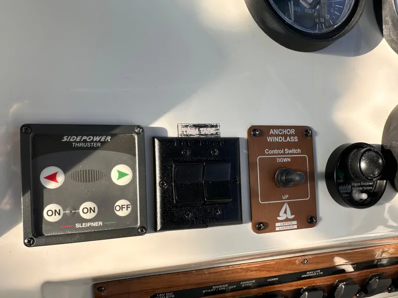 Slide: The Image of Control panel of a 2001 Mainship Pilot 30 with Sidepower thruster and anchor windlass switches. - 14