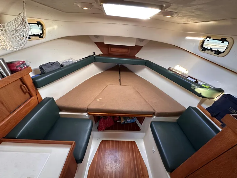 Slide: The Image of 2001 Mainship Pilot 30 cabin interior with seating and storage. - 16