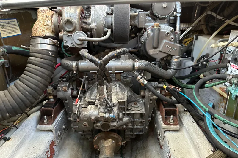 Slide: The Image of Engine compartment of a 2001 Mainship Pilot 30 boat, showcasing mechanical components and wiring. - 24