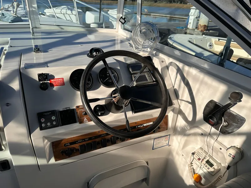 Slide: The Image of 2001 Mainship Pilot 30 boat cockpit with steering wheel and control panel. - 6