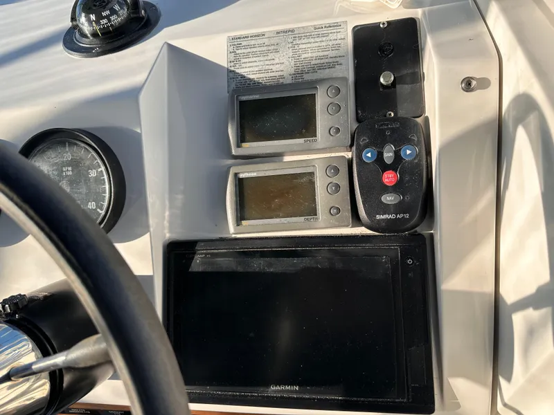 Slide: The Image of Control panel of a 2001 Mainship Pilot 30 boat with navigation instruments. - 7